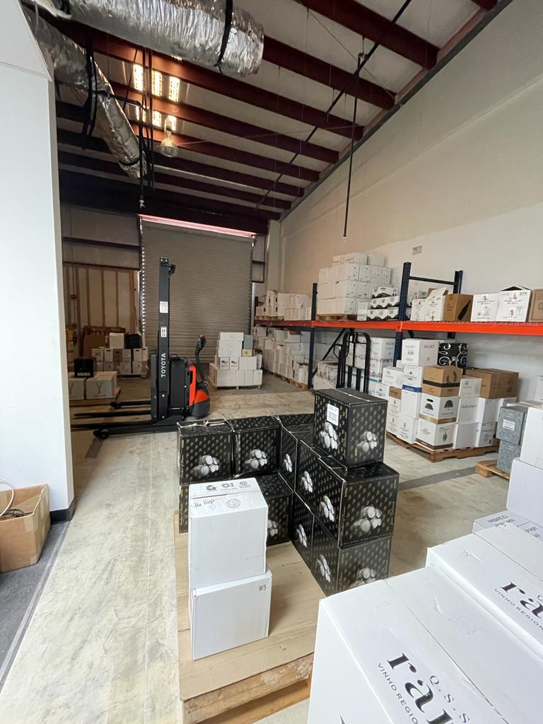 A warehouse filled with lots of boxes and a forklift.