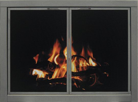 Fireplace with burning logs behind mesh screen doors. Orange flames against dark background.