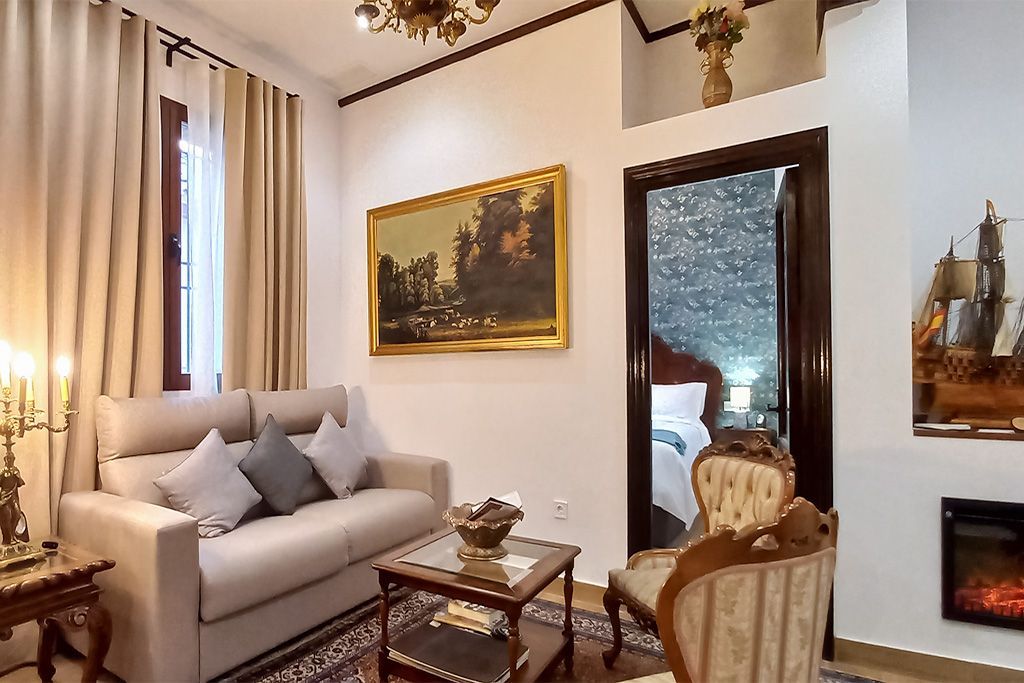 A living room with a couch , chair , coffee table and fireplace.