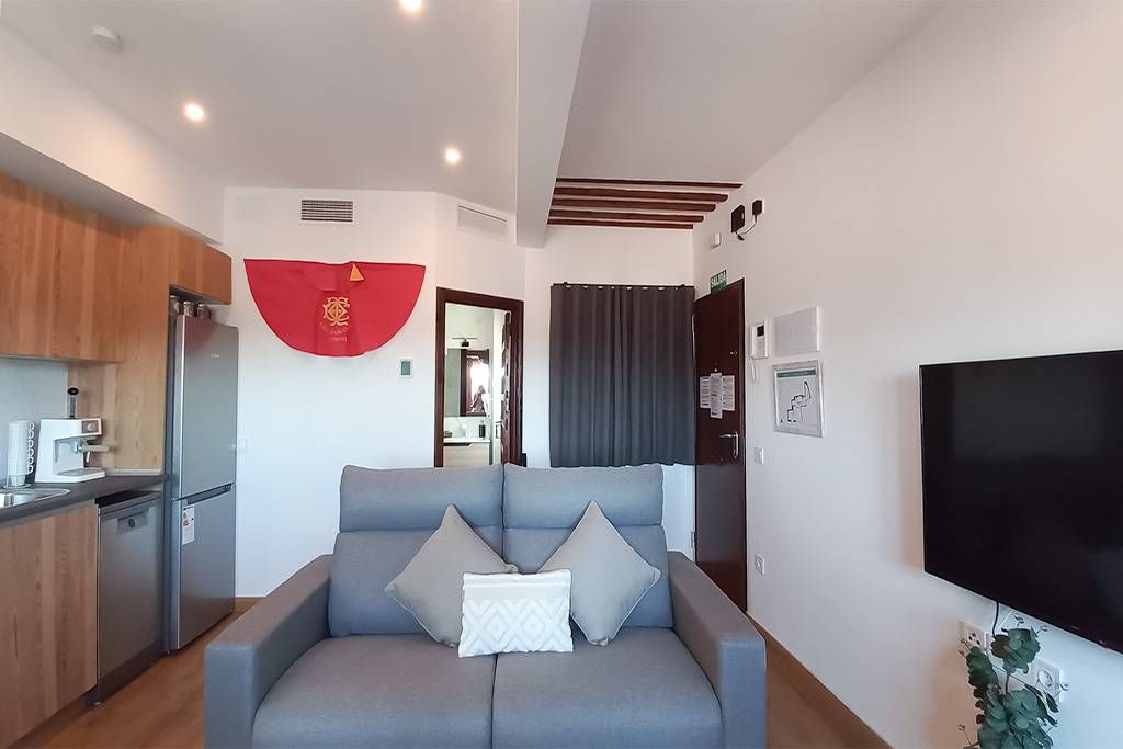 A living room with a couch and a flat screen tv