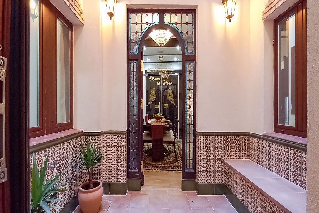 A hallway leading to a room with a table and chairs