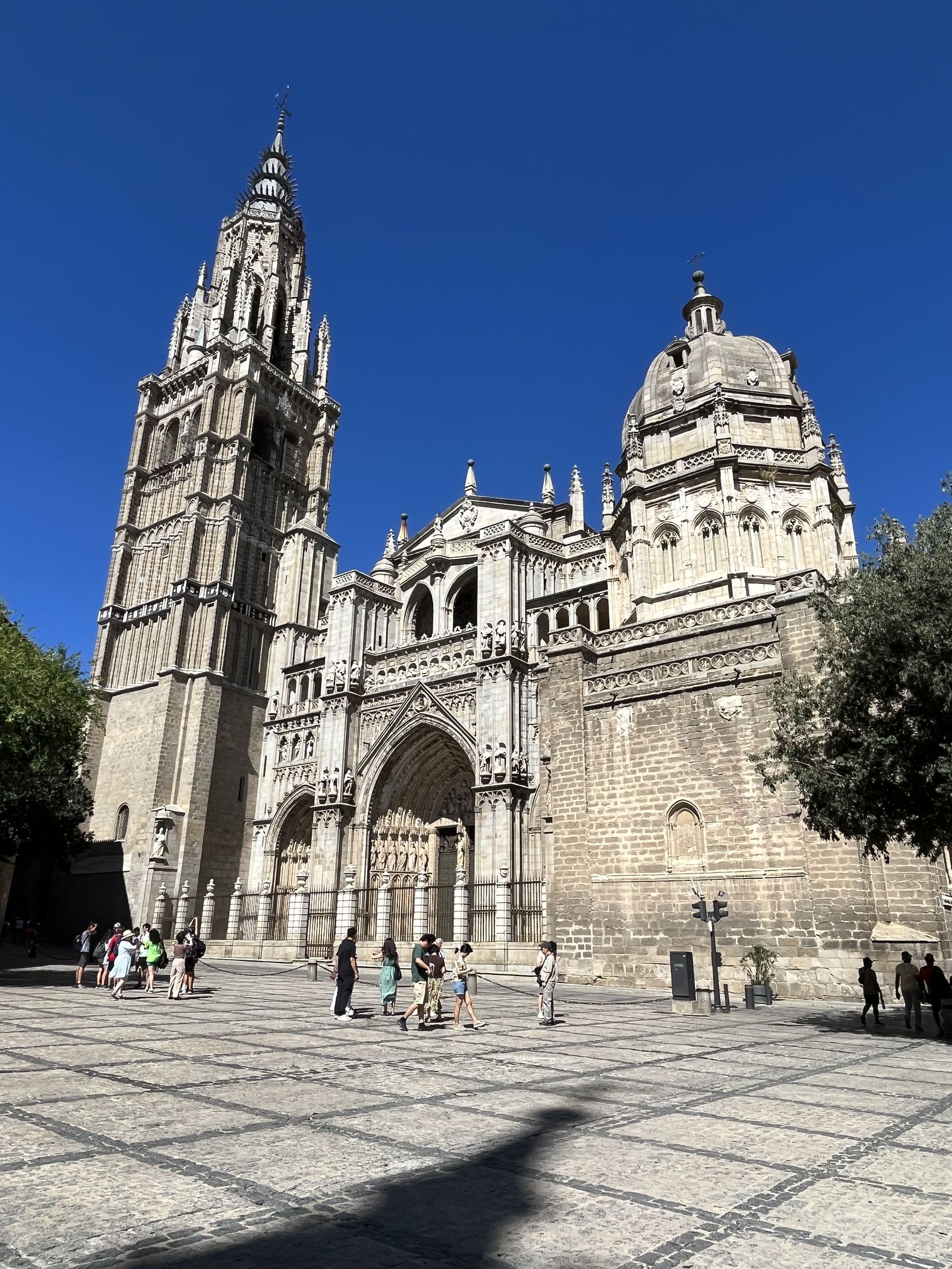 A group of people are standing in front of a large building.