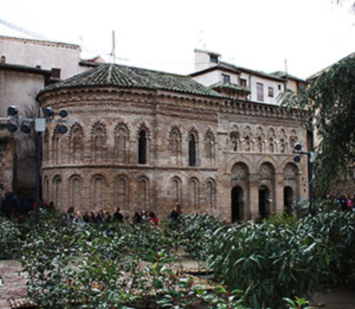 A group of people are standing in front of a large building