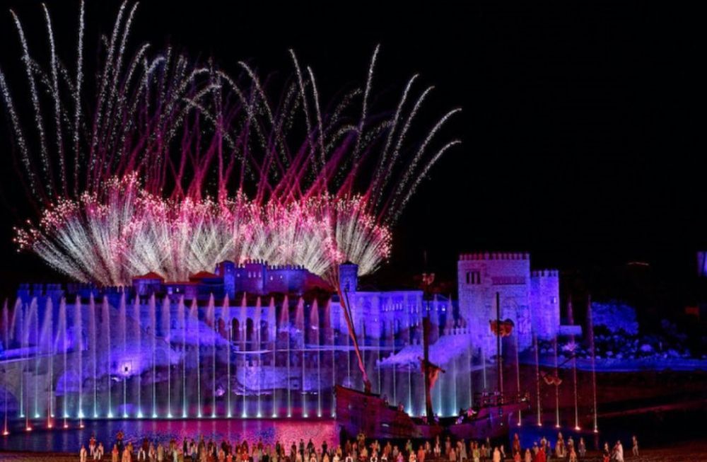 A fireworks display is taking place in front of a large building.