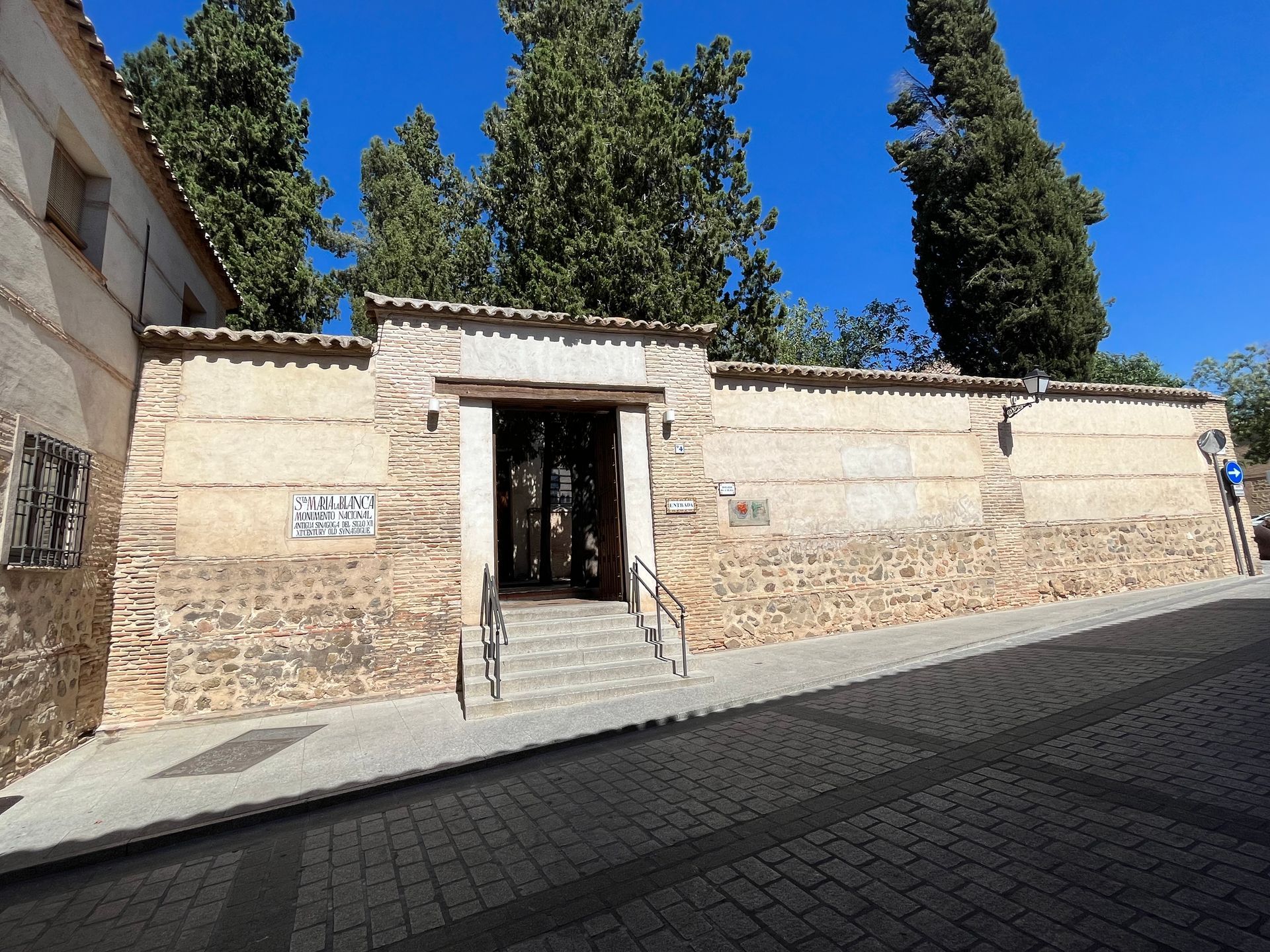 A brick building with stairs leading up to it