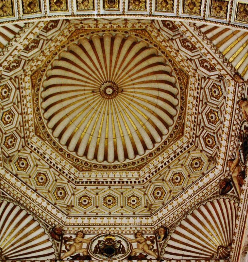 The ceiling of a building with a dome and angels on it.