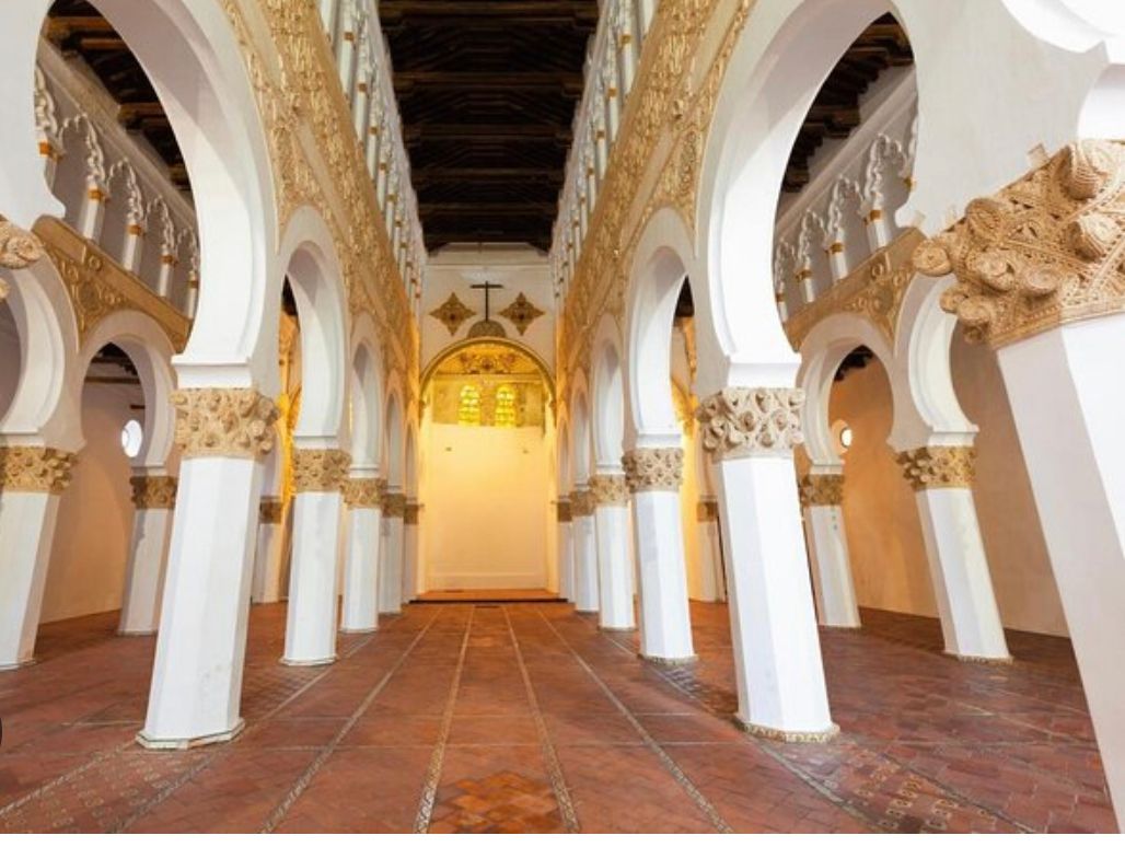 The inside of a building with arches and columns