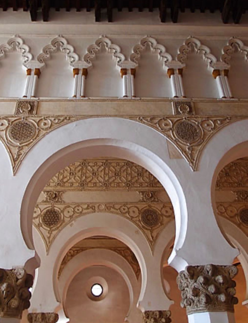 The inside of a building with arches and columns