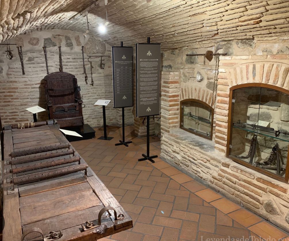 A room with a wooden chair and a brick wall