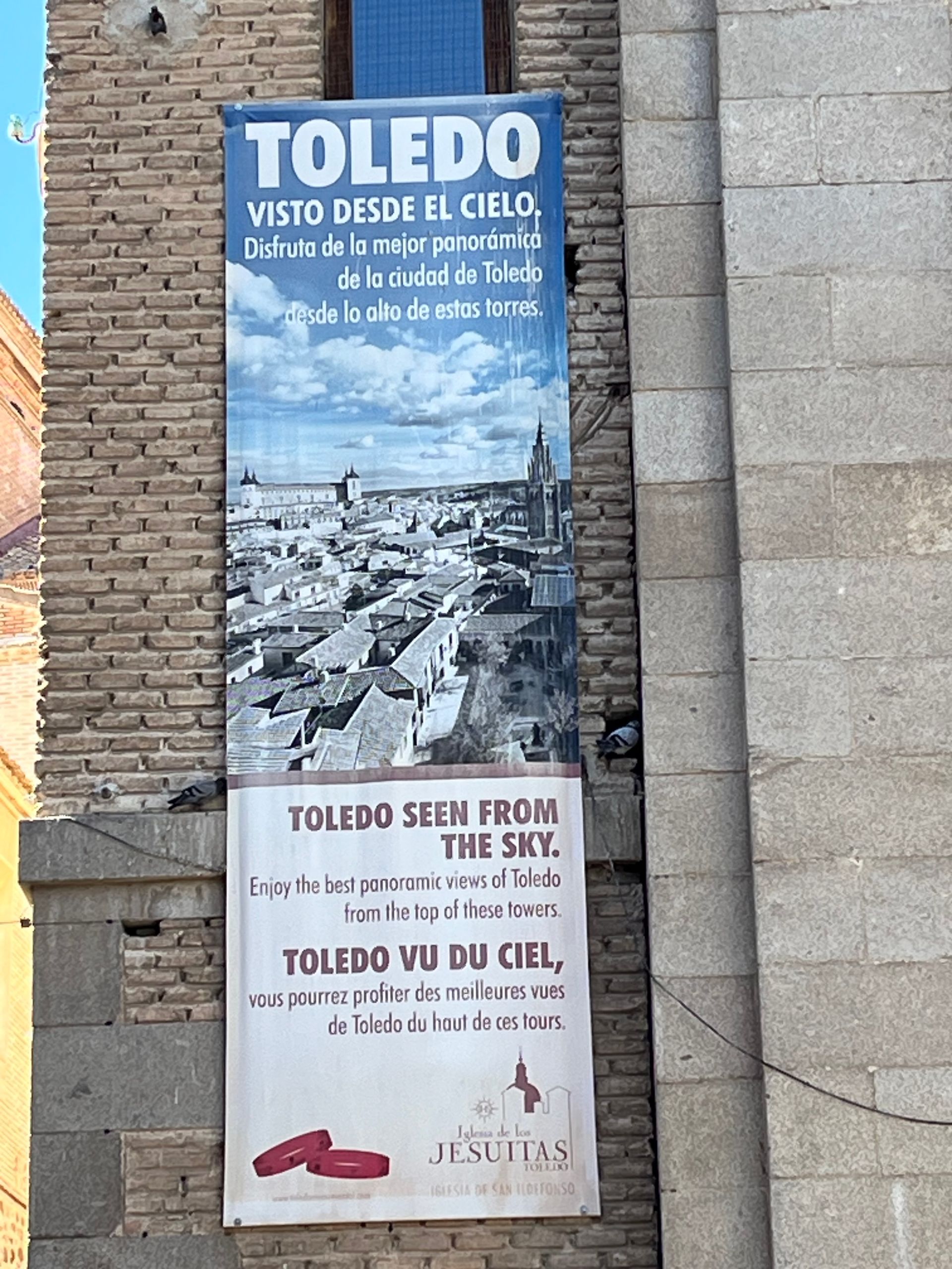 A toledo banner hangs on a brick wall