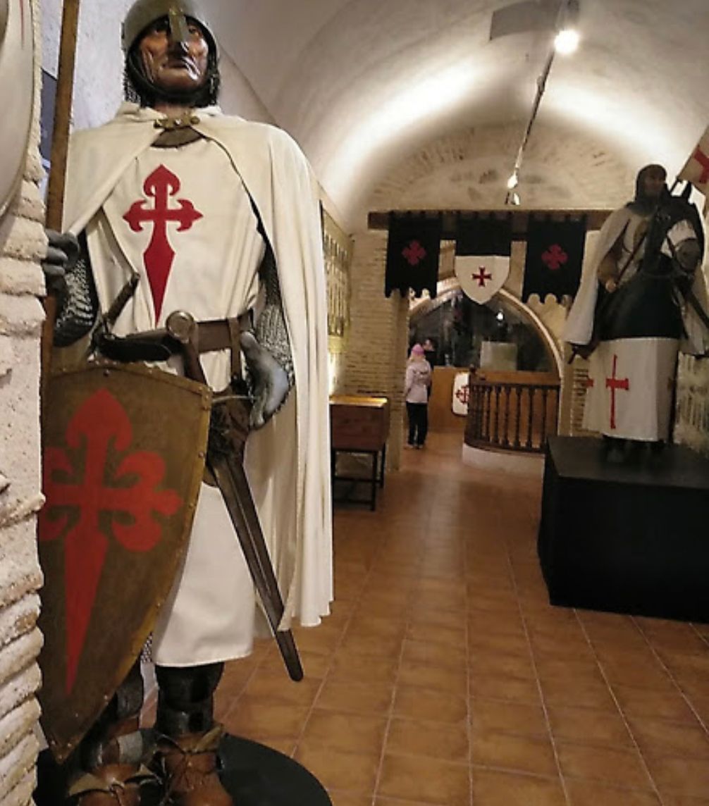 A statue of a knight with a cross on his chest