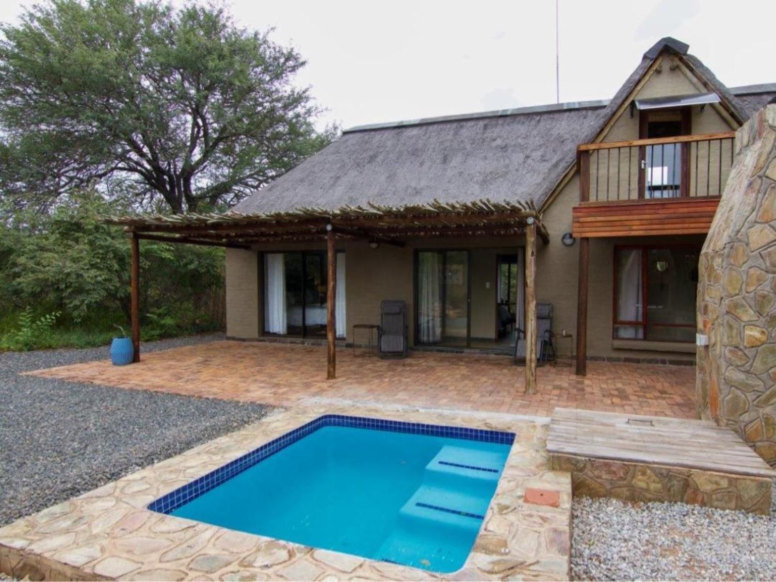 a house with a swimming pool in front of it