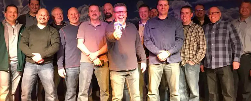 A group of men are standing next to each other on a stage.