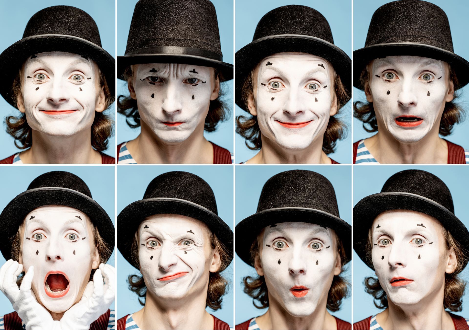 um mímico está usando um chapéu e tem muitos rostos diferentes pintados no rosto.