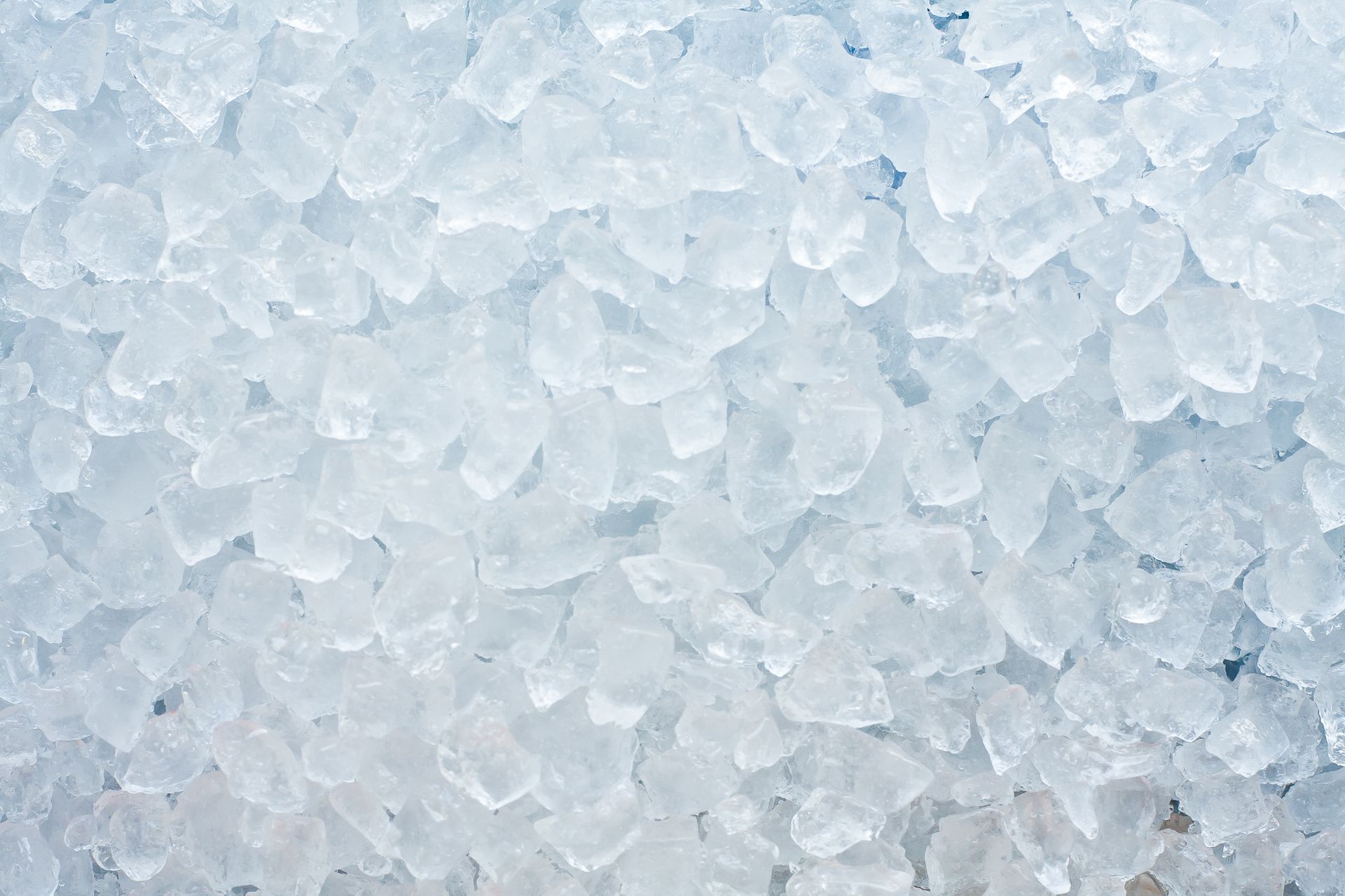 Close-up of a pile of crushed ice, varying shades of white and blue.