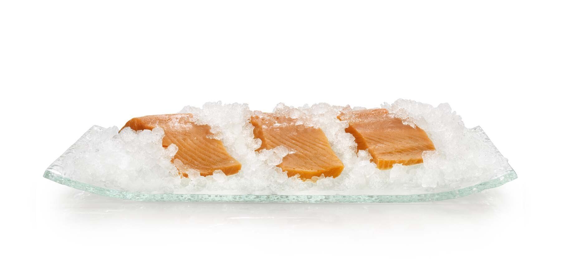 A plate of food covered in ice on a white background.