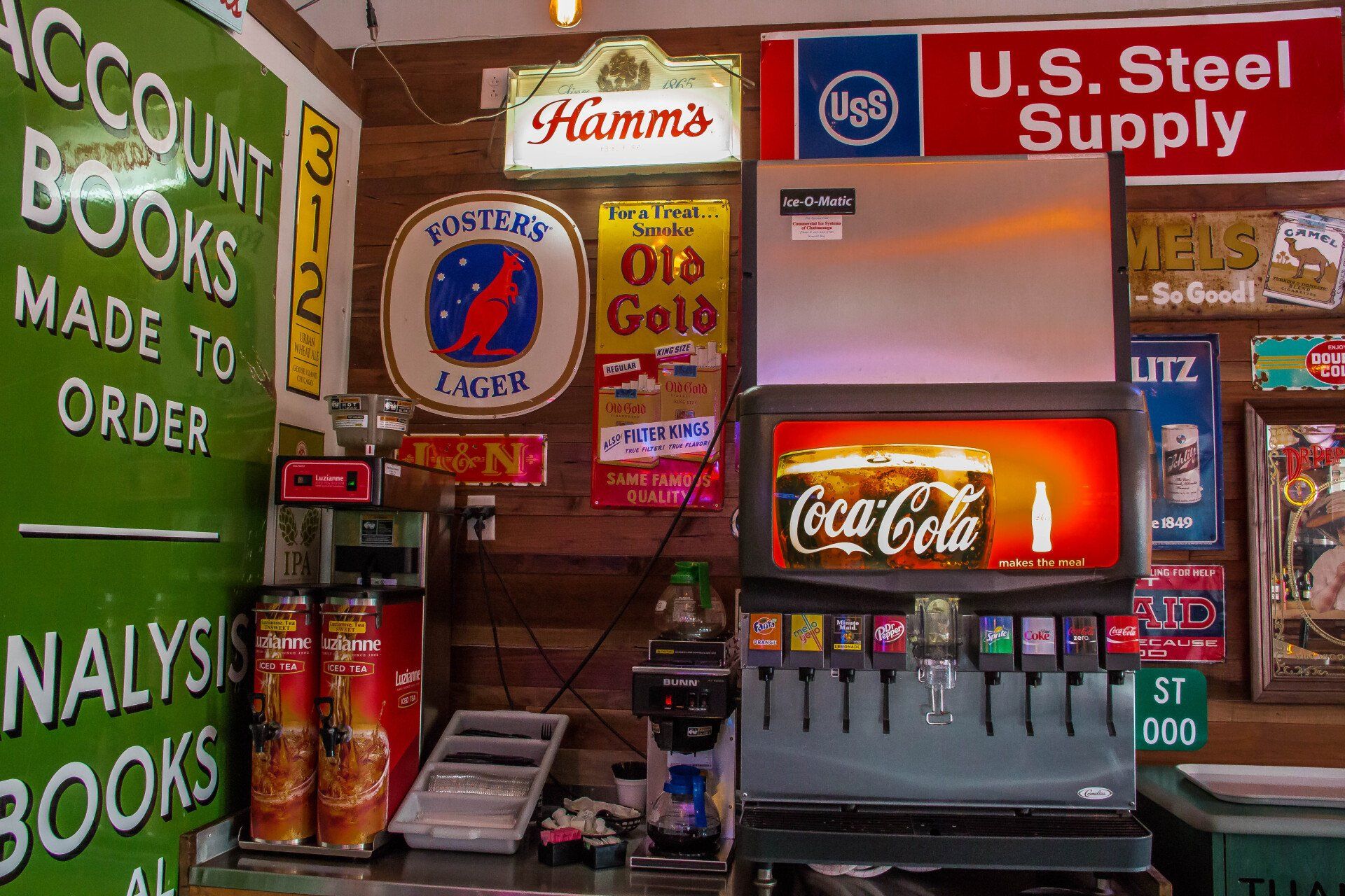 A coca cola machine in a store with a sign that says u.s. steel supply