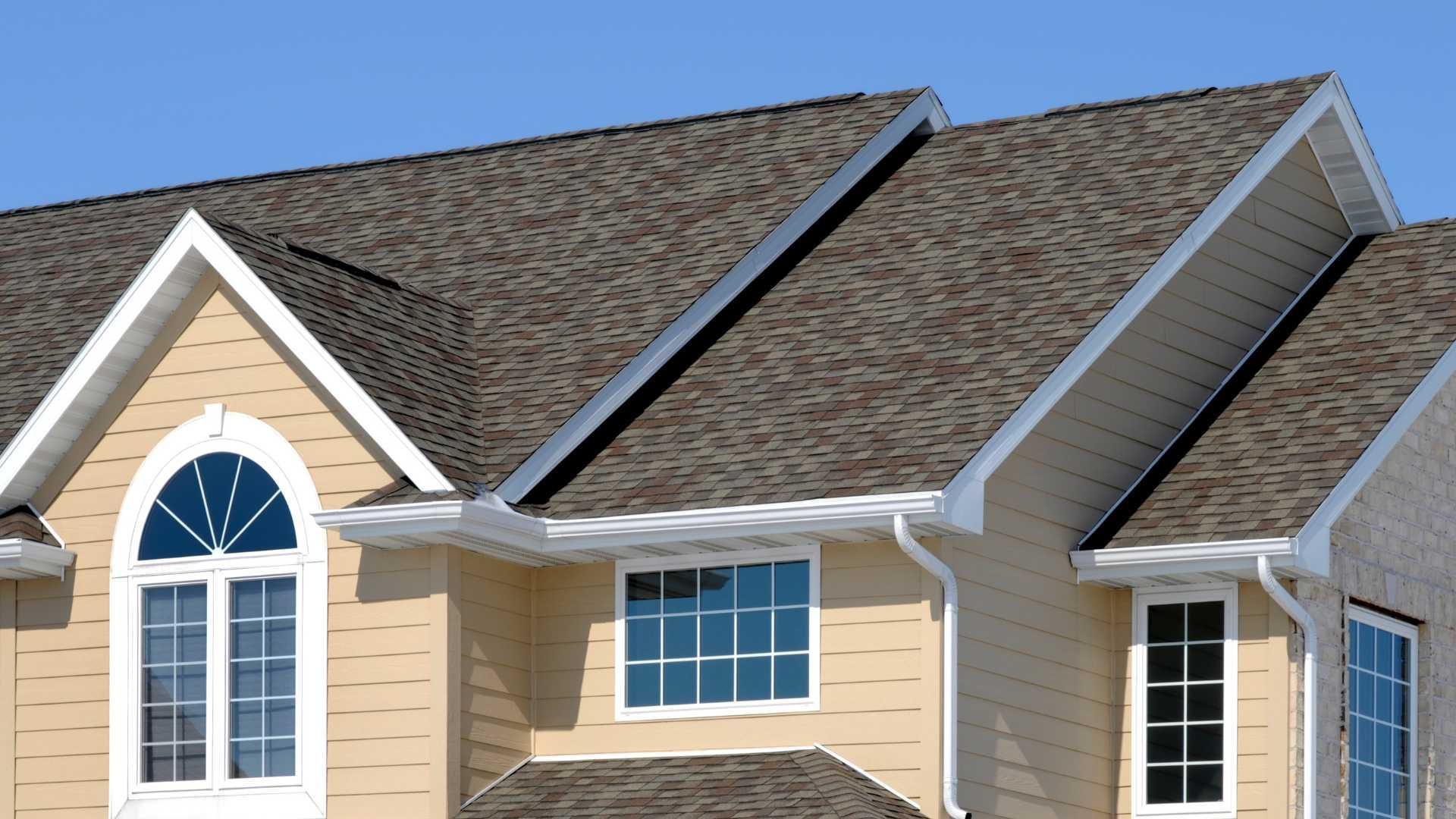 A house with a brown roof and white trim