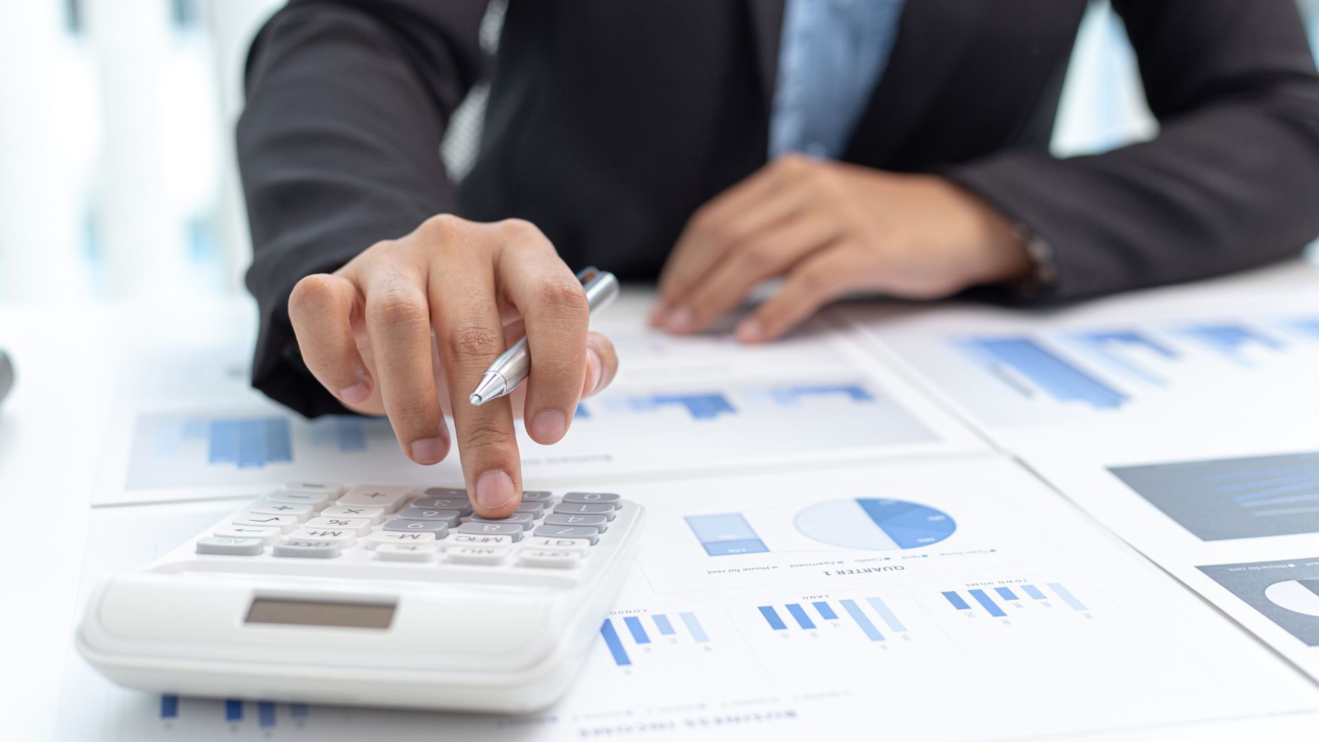 A close up of black nailable solar shingles attached to a roof