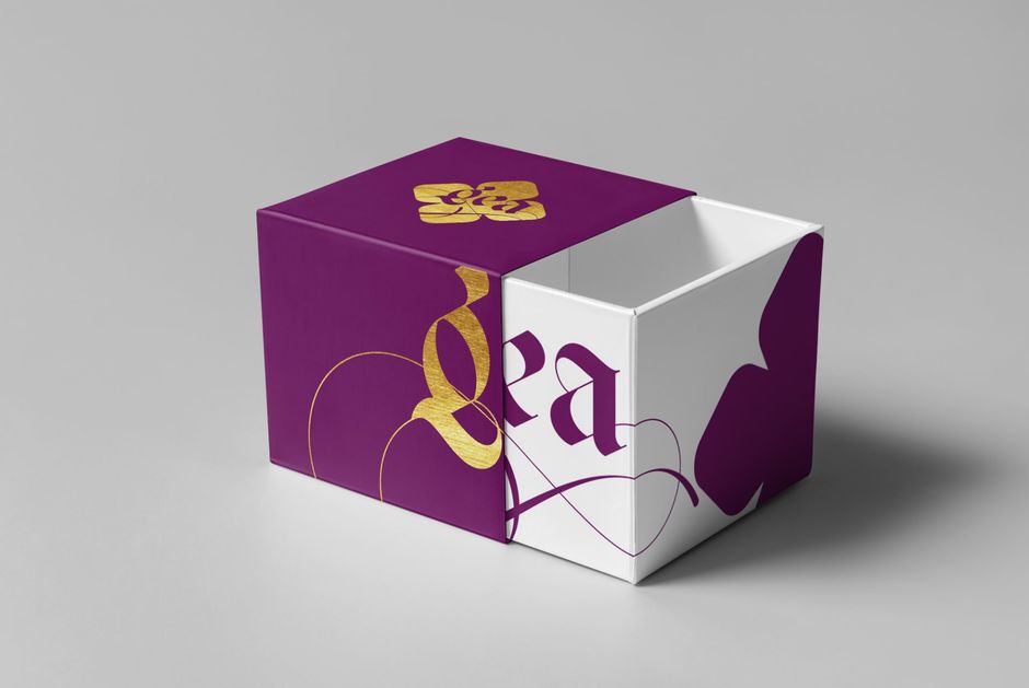 Purple and white box with gold accents, showing open sliding design.