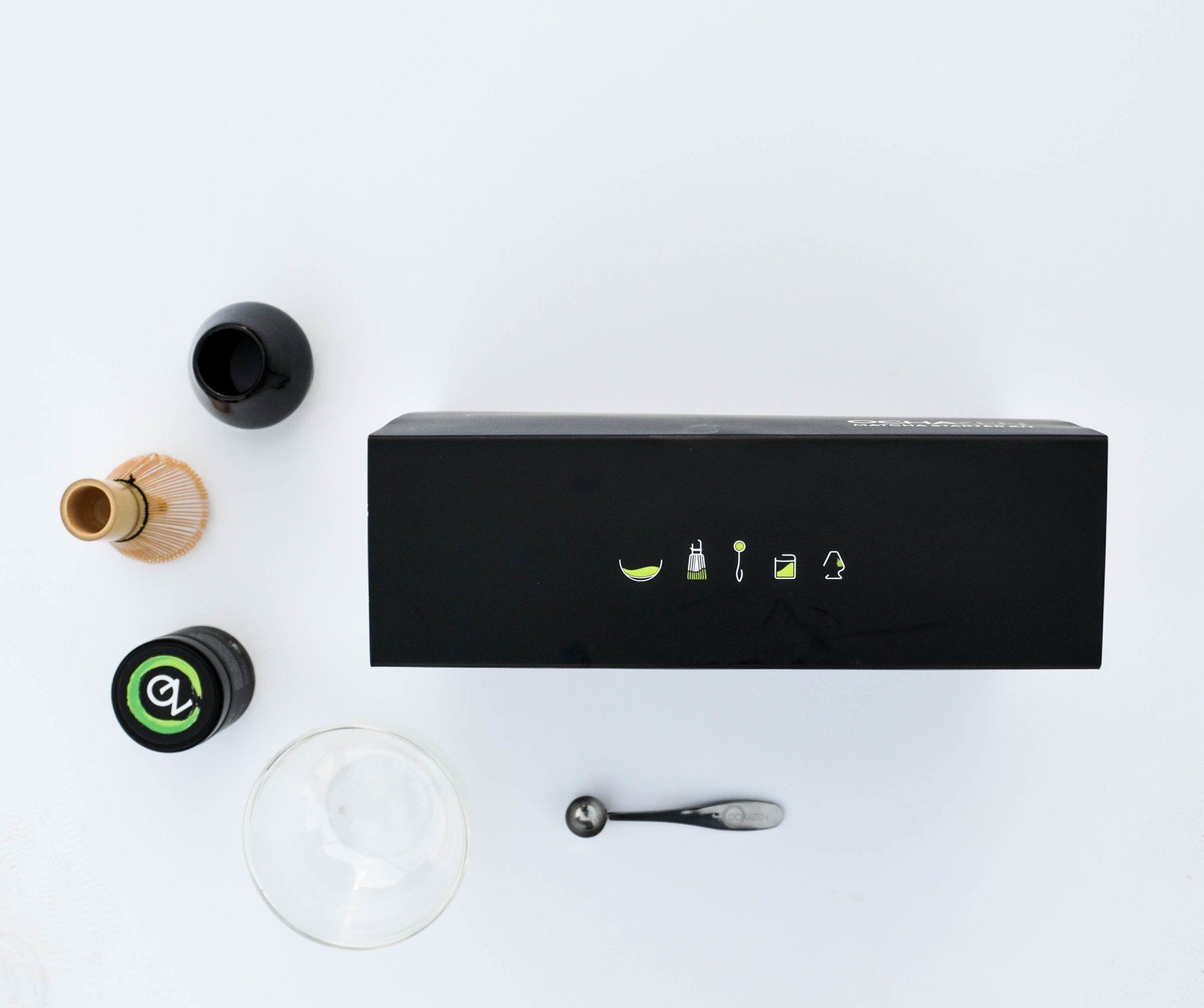 Black matcha gift set with bowl, whisk, cup, scoop, and matcha tin on white surface.