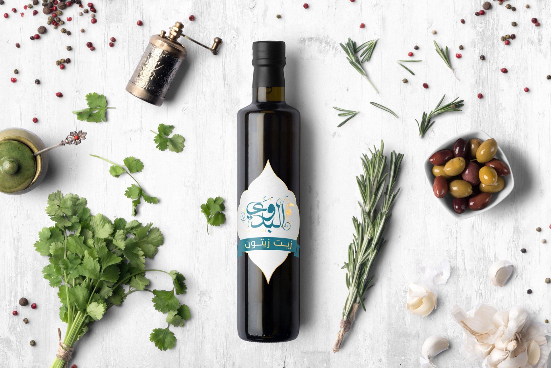 Bottle of olive oil with label, surrounded by herbs, spices, and olives.