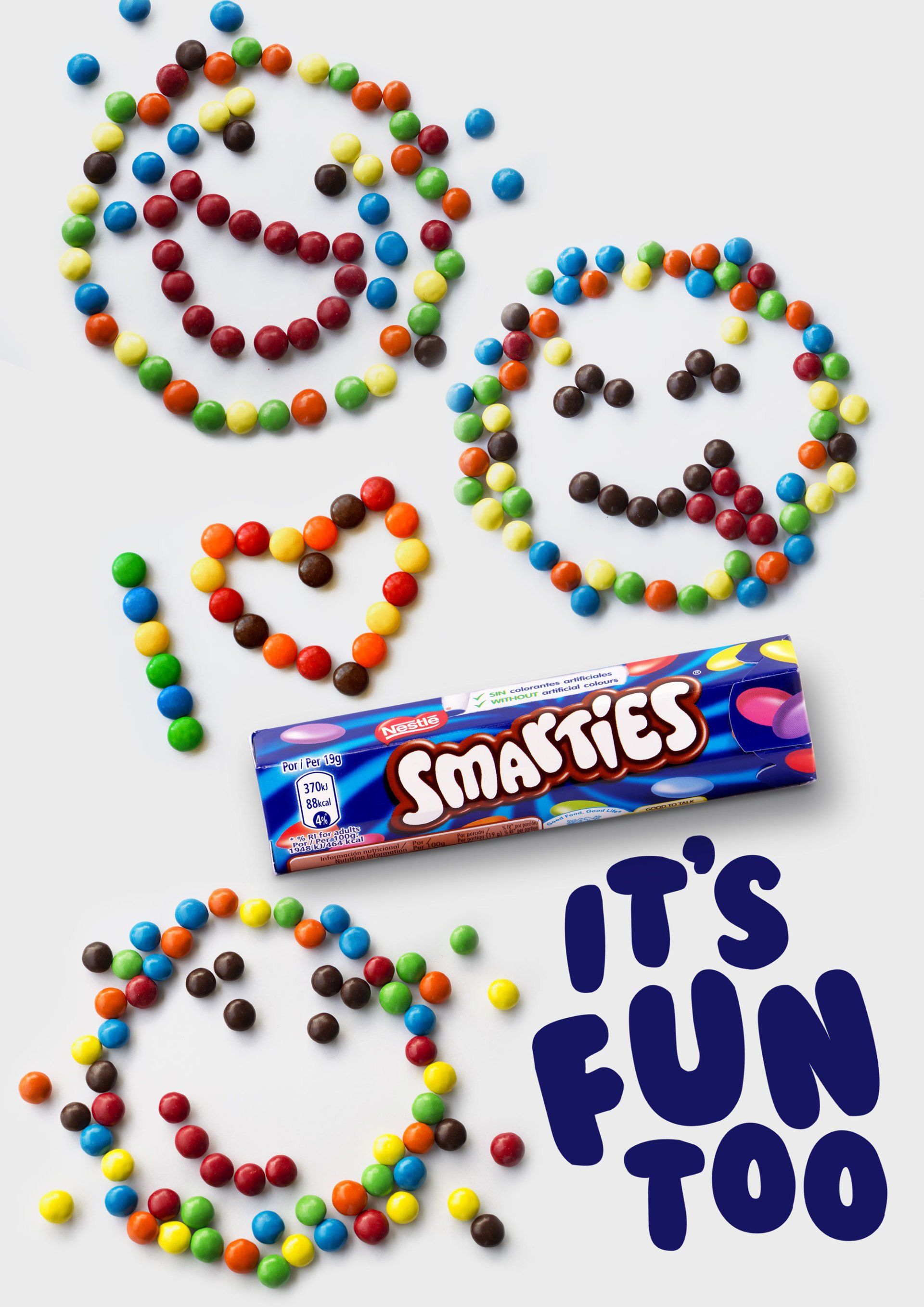 Smarties candies arranged in shapes, with a package, and the words 