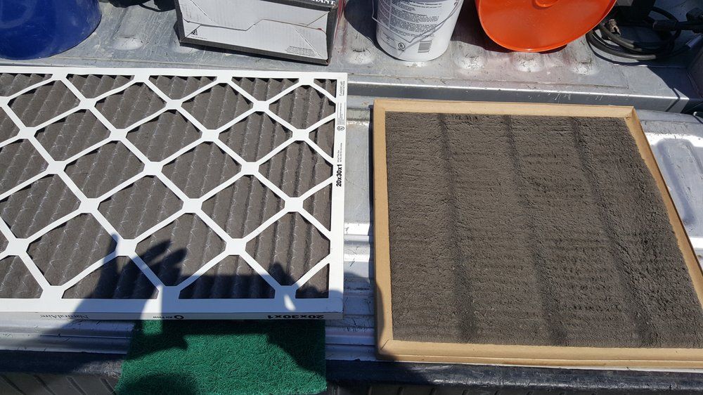 Two HVAC air filters: one clean, one heavily soiled with dark debris.