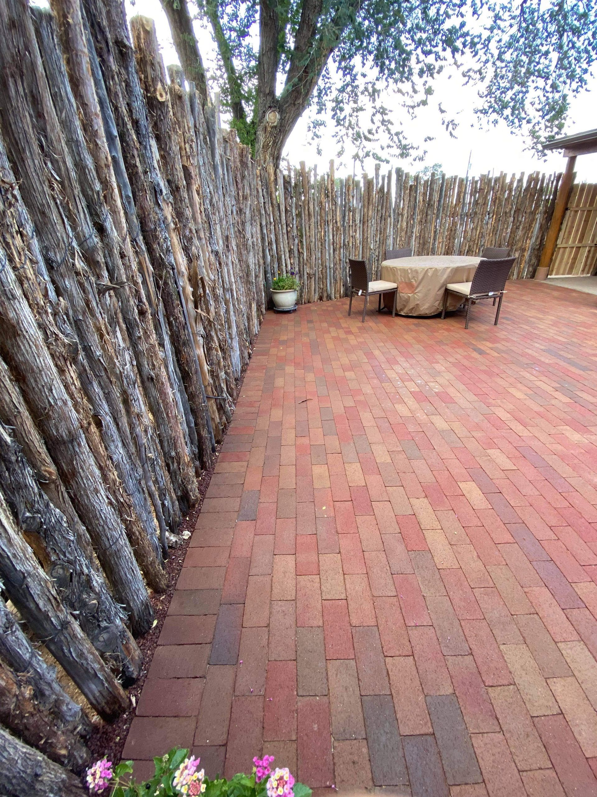 Coyote latilla fence with brick courtyard patio in Santa Fe NM outdoor remodel