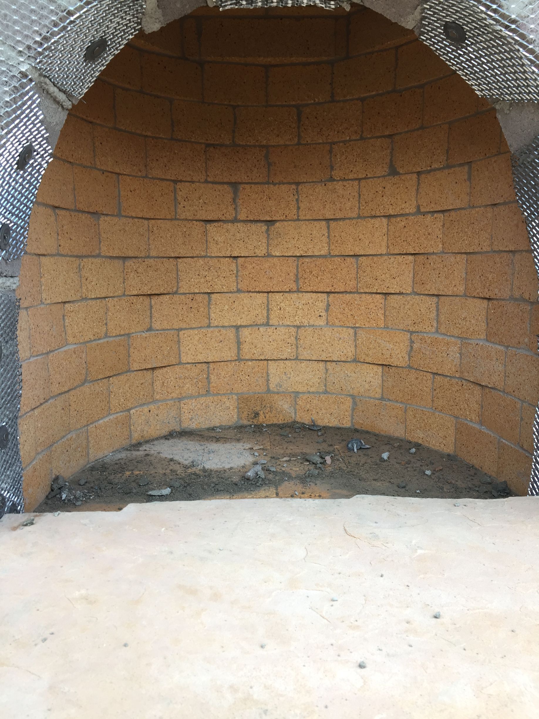 Custom outdoor kiva-style fireplace construction in Santa Fe NM 