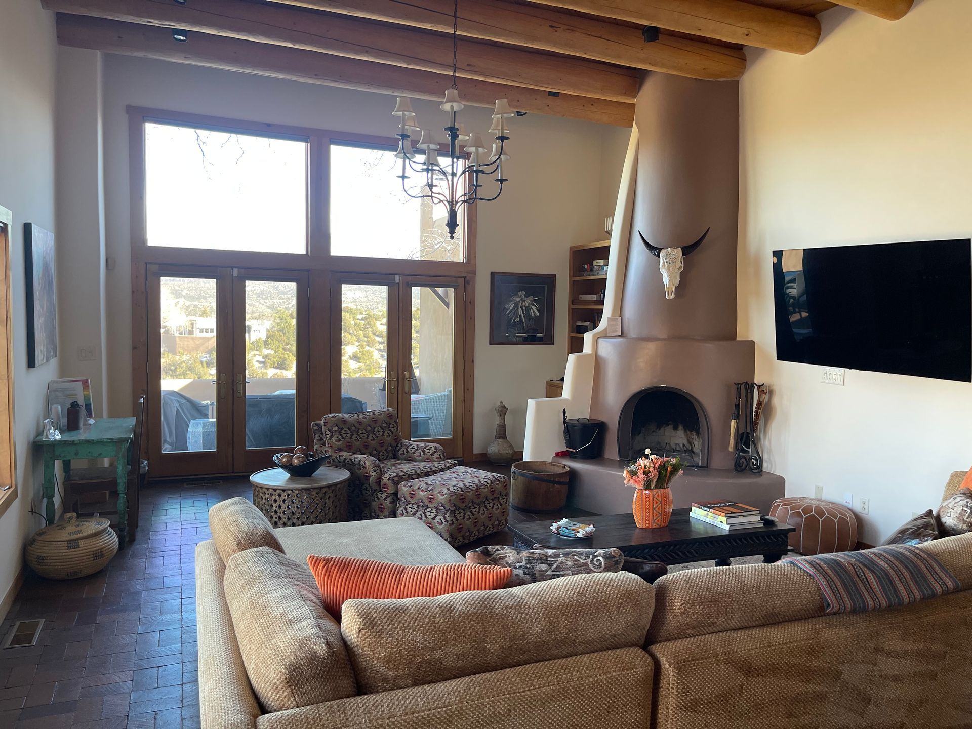Living room remodel featuring custom kiva fireplace with diamond plaster finish in Santa Fe NM