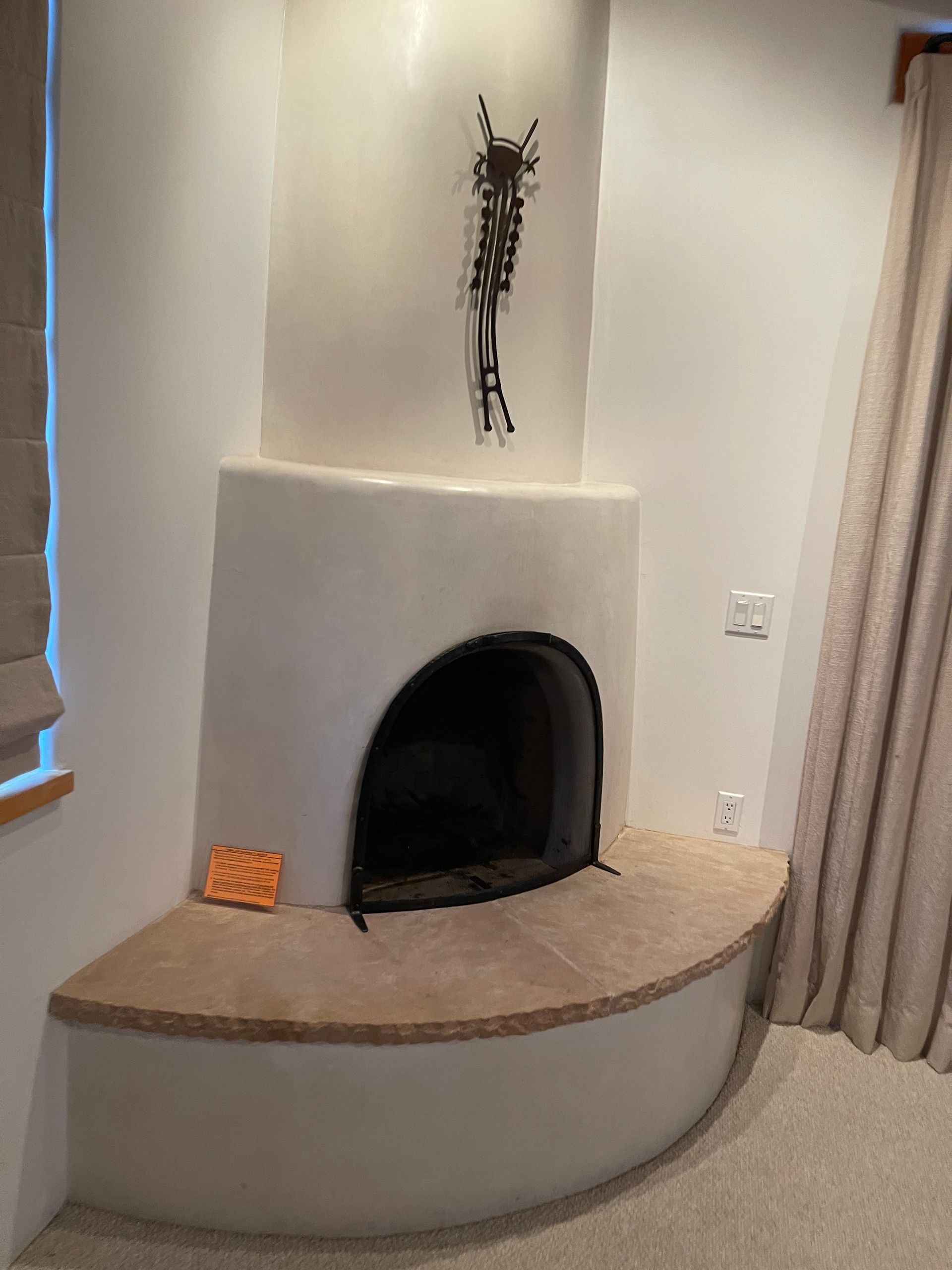 Kiva fireplace upgrade with custom plaster color and diamond finish in Santa Fe NM home