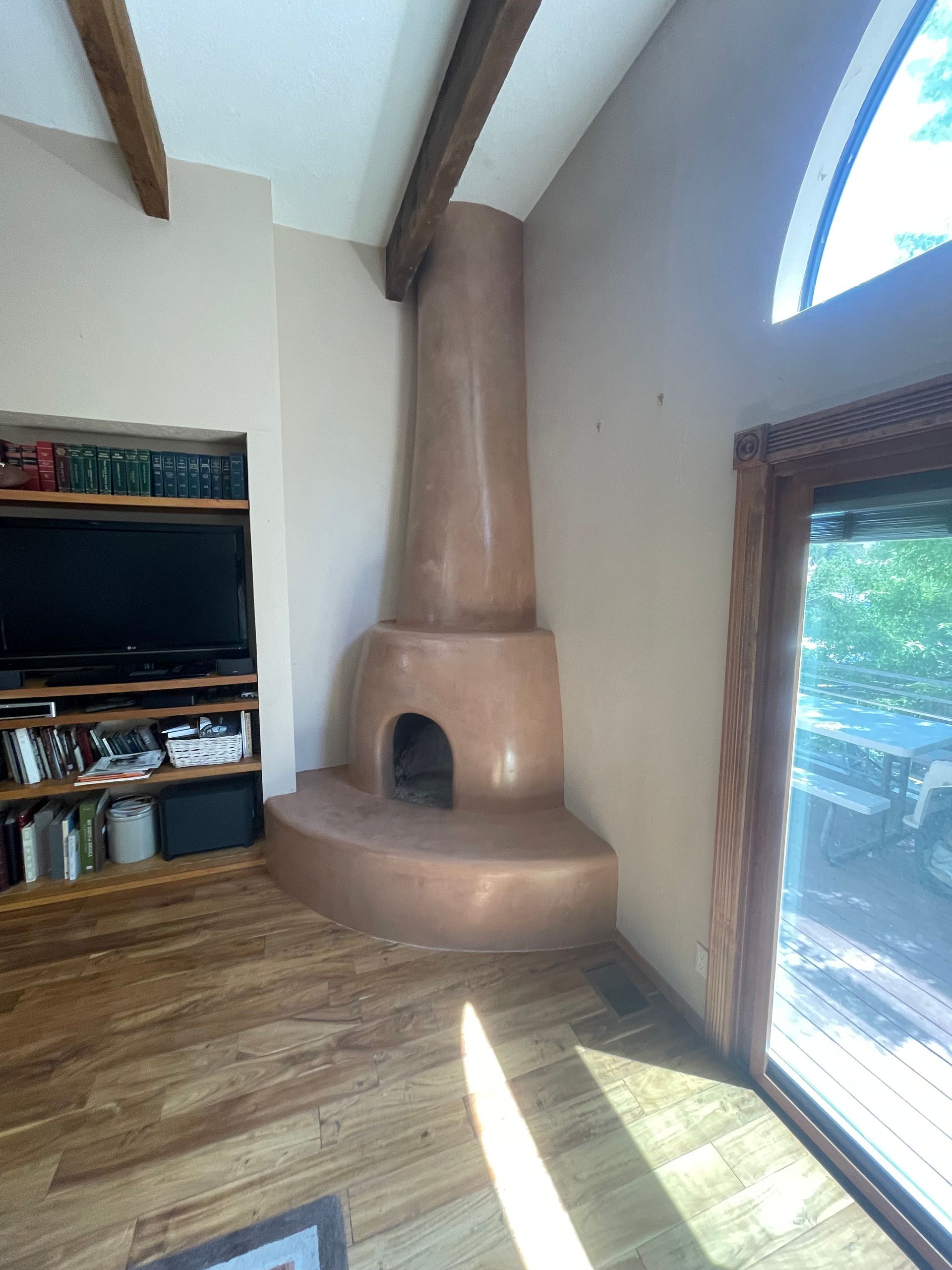 Kiva fireplace renovation with smooth diamond plaster and custom finish in Santa Fe NM