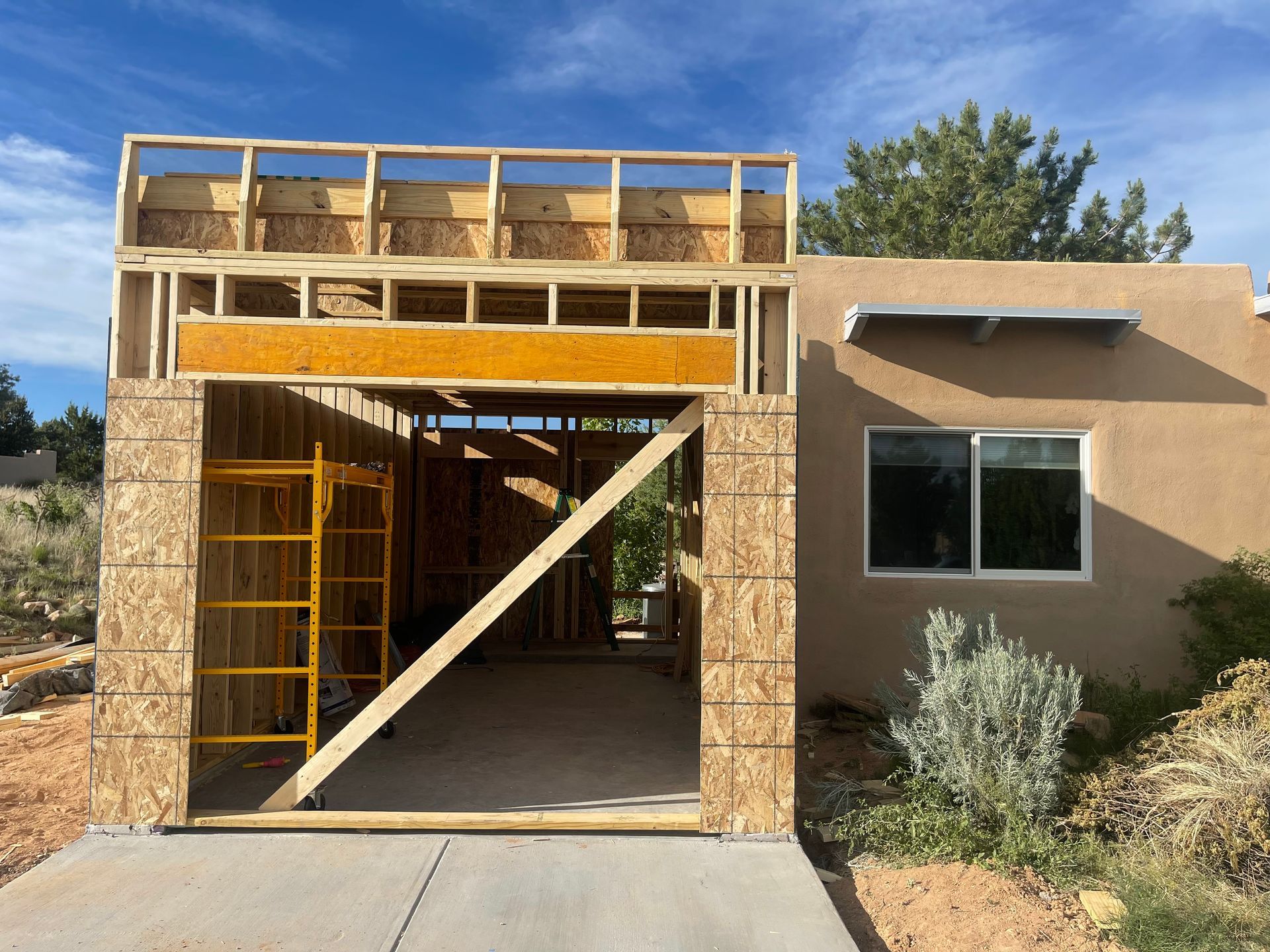 A house under construction with a new garage addition in Eldorado NM 