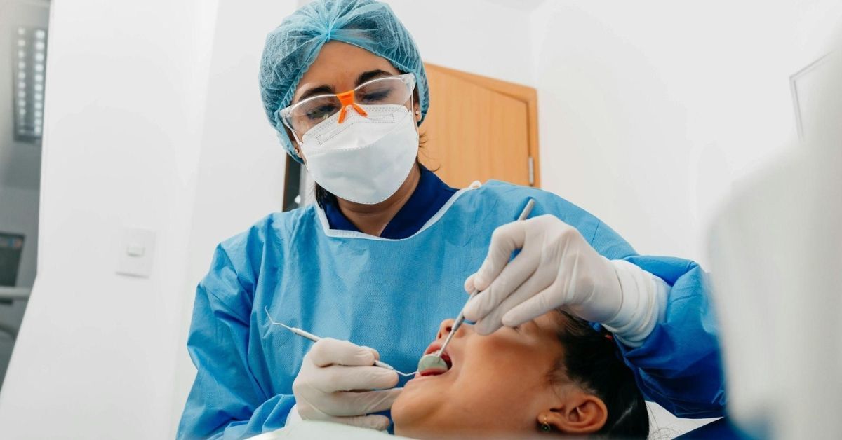 Pediatric dentist examining a child’s chipped tooth 