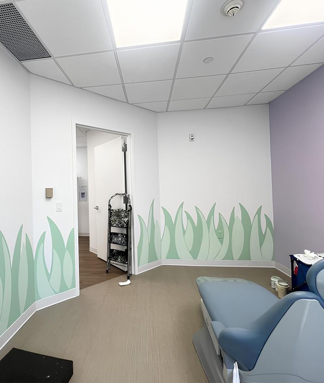 Pediatric dentist treatment room in Hastings-On-Hudson featuring dental chair, playful wall art, and child-friendly design at Next Level Pediatric Dentistry.