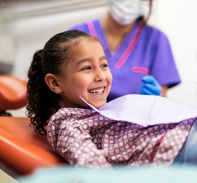 Smiling child in dental chair, pediatric dentist in Tarrytown NY