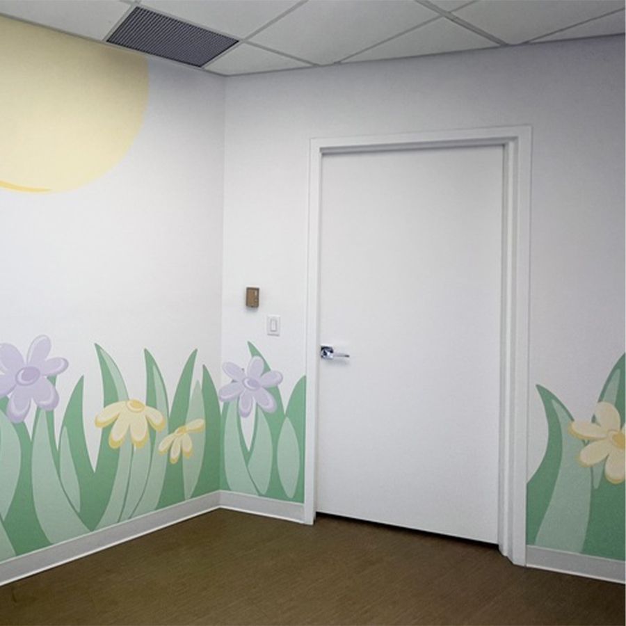 Pediatric dentist office in Nyack with playful floral wall mural and cheerful design to create a welcoming atmosphere for children.
