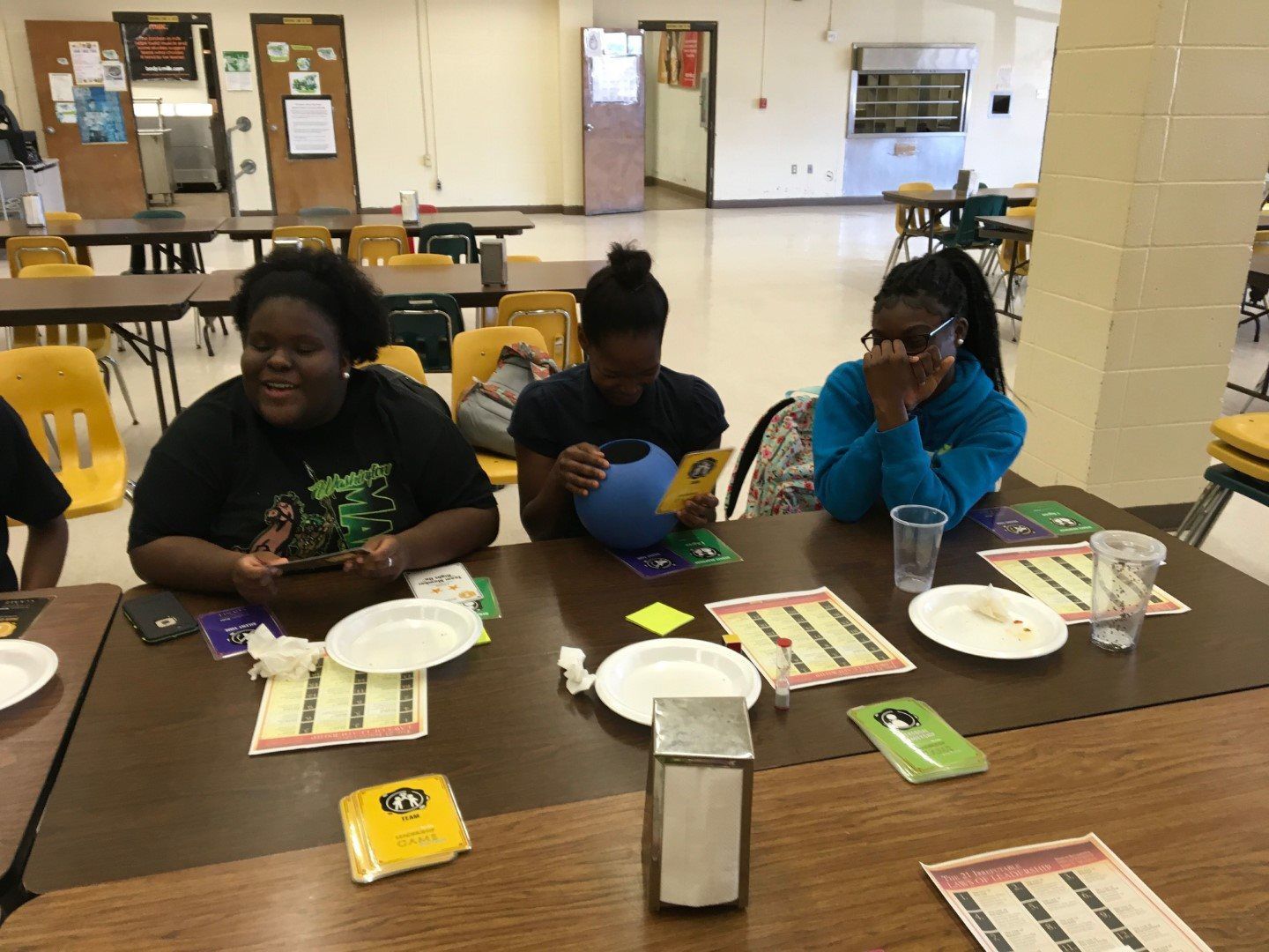 A group of people are sitting at a table with plates and glasses.
