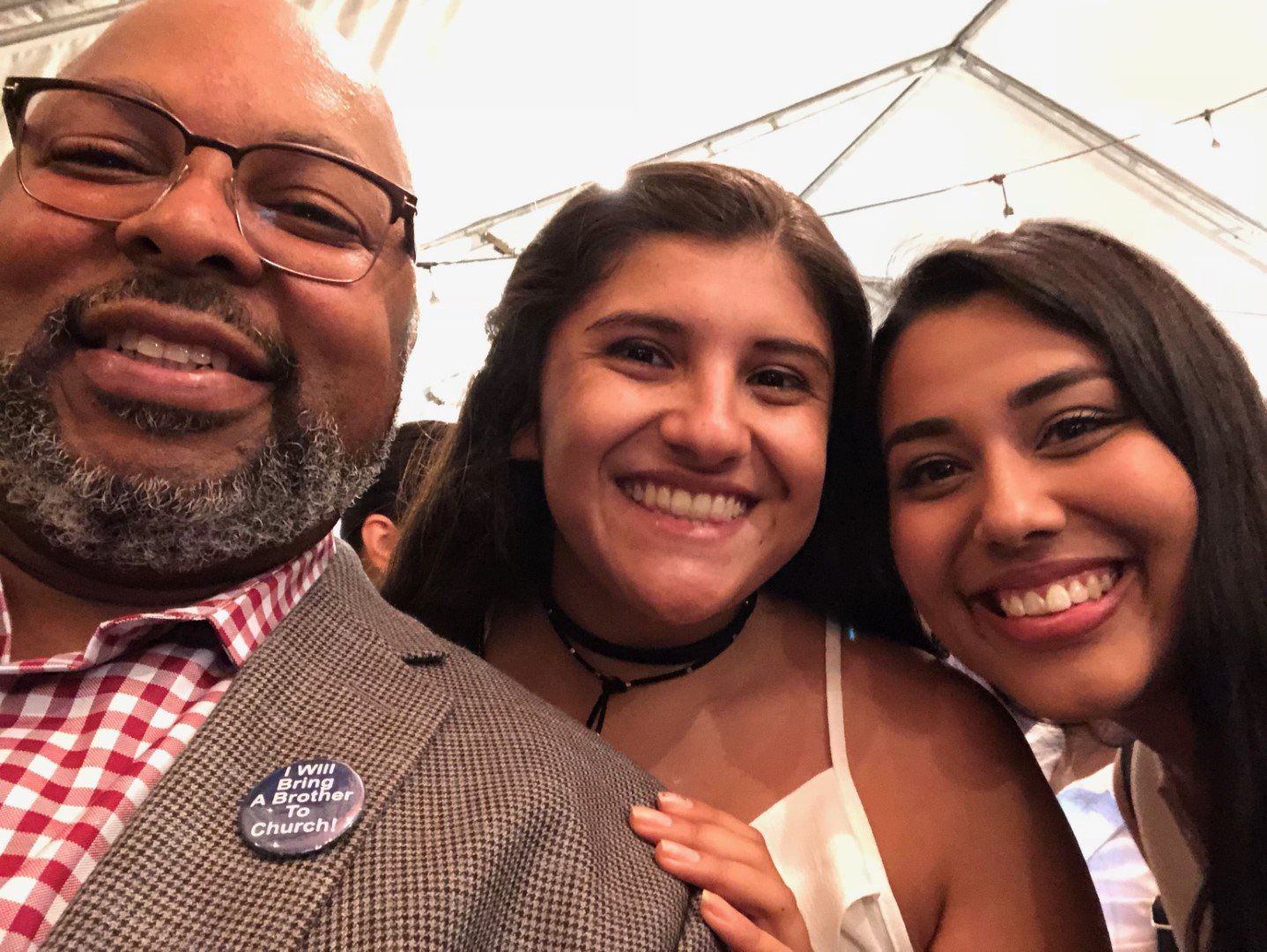 A man and two girls are posing for a picture together