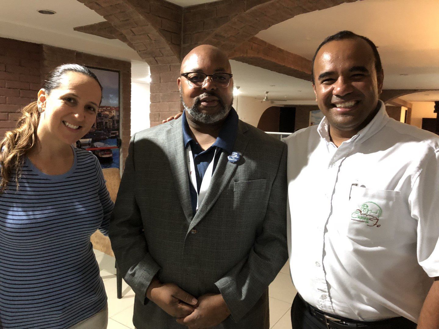 Two men and a woman are posing for a picture together