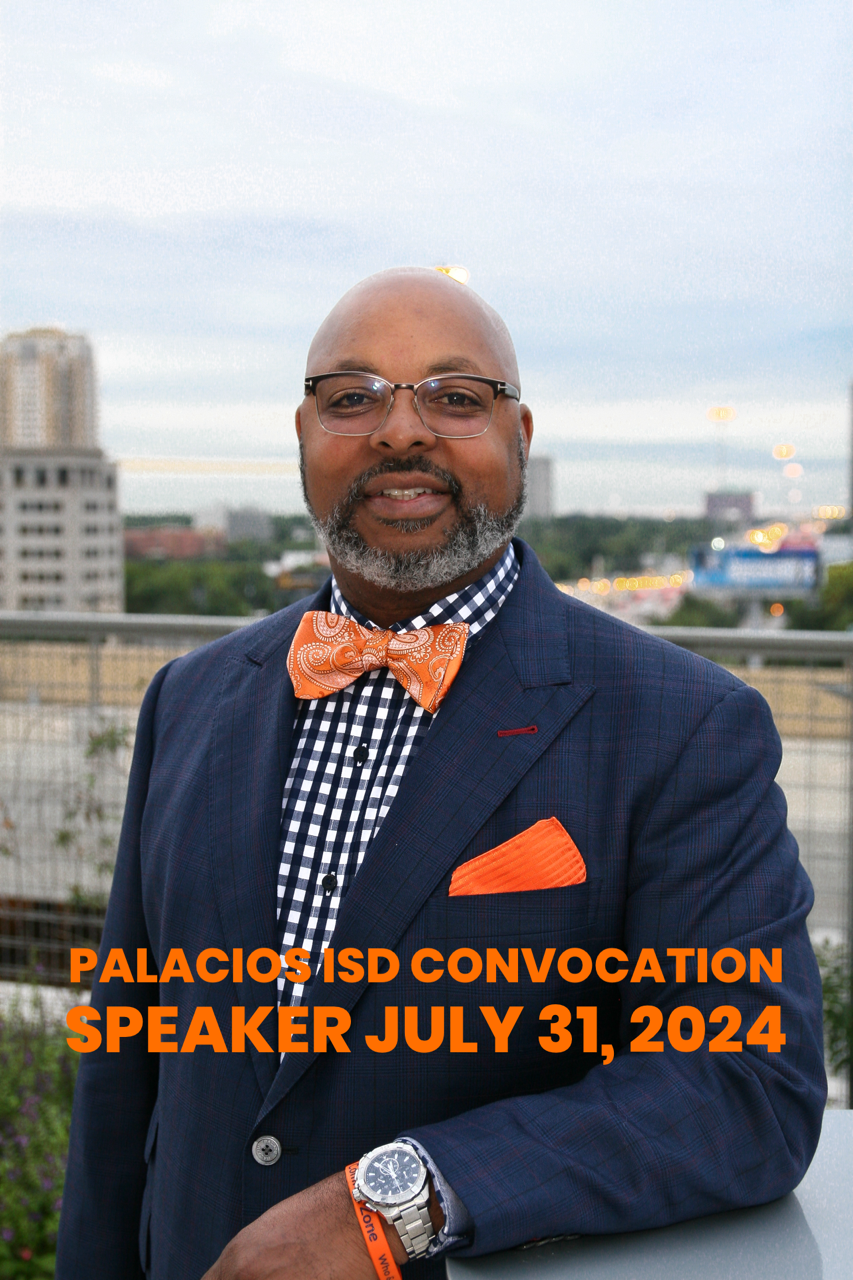 A man in a suit and bow tie is standing on a balcony.
