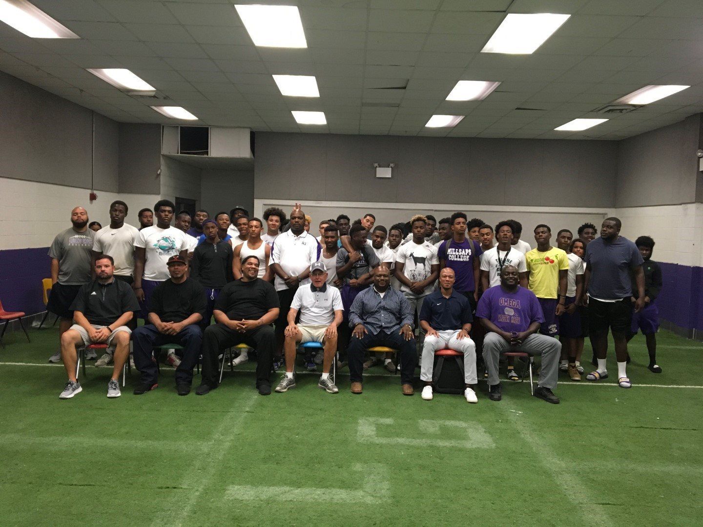 A group of people are posing for a picture in a room.