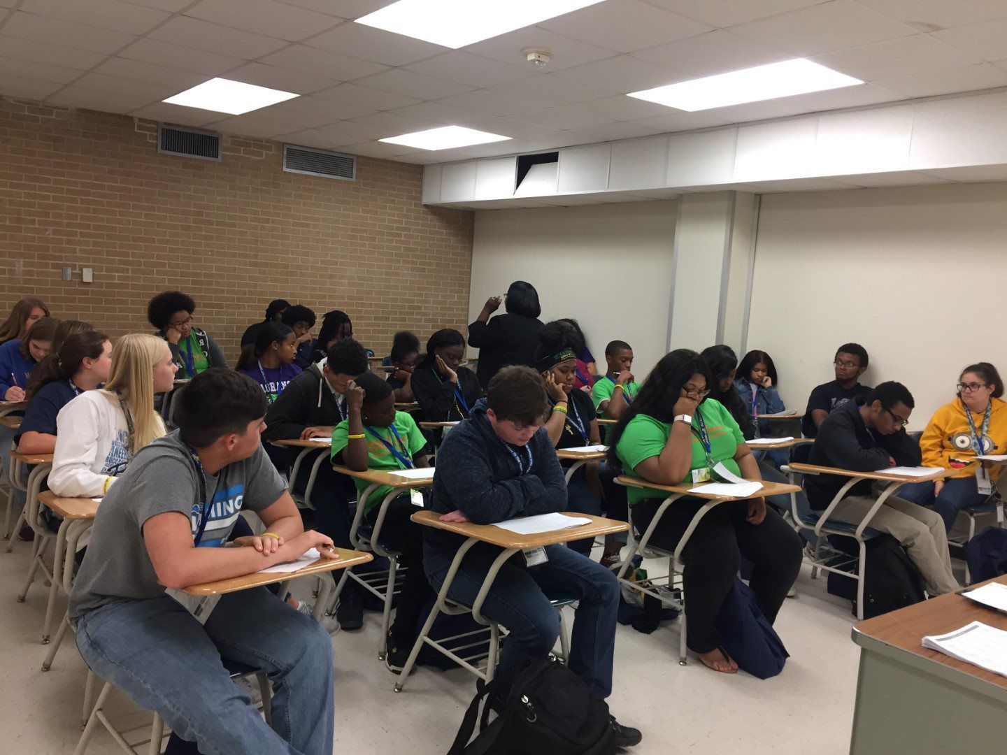 A group of students are sitting at desks in a classroom.