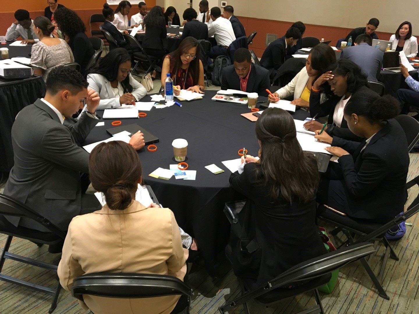 A group of people are sitting around a table in a room.