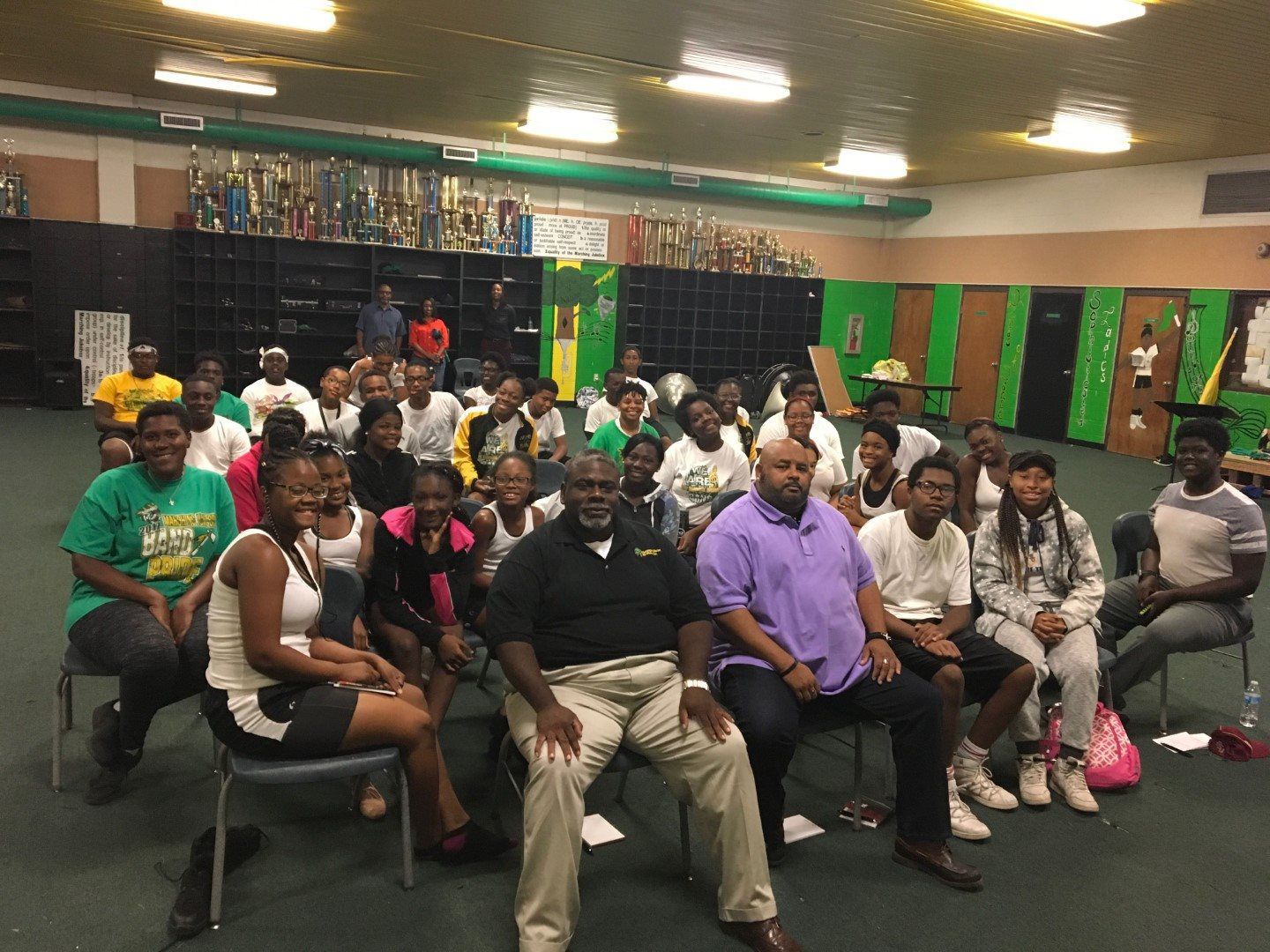 A group of people are sitting in chairs in a room.