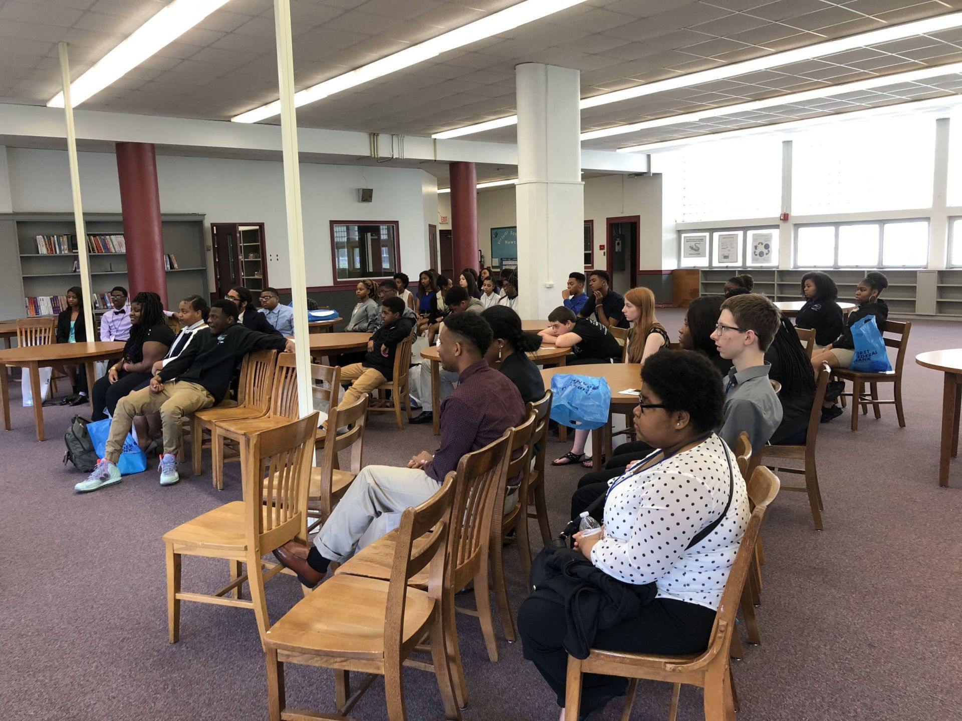 A group of people are sitting in chairs in a room.
