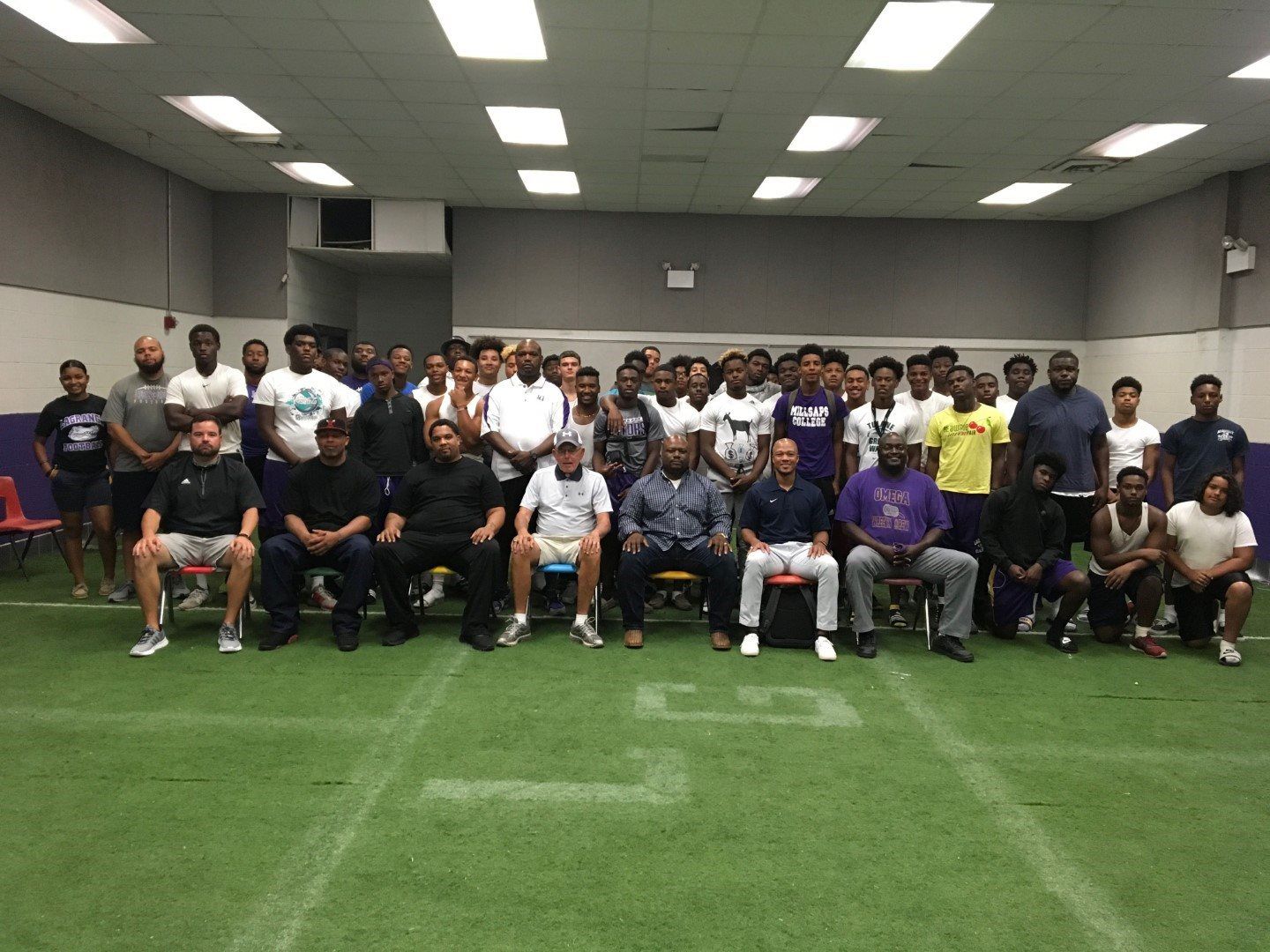A group of people are posing for a picture in a room.