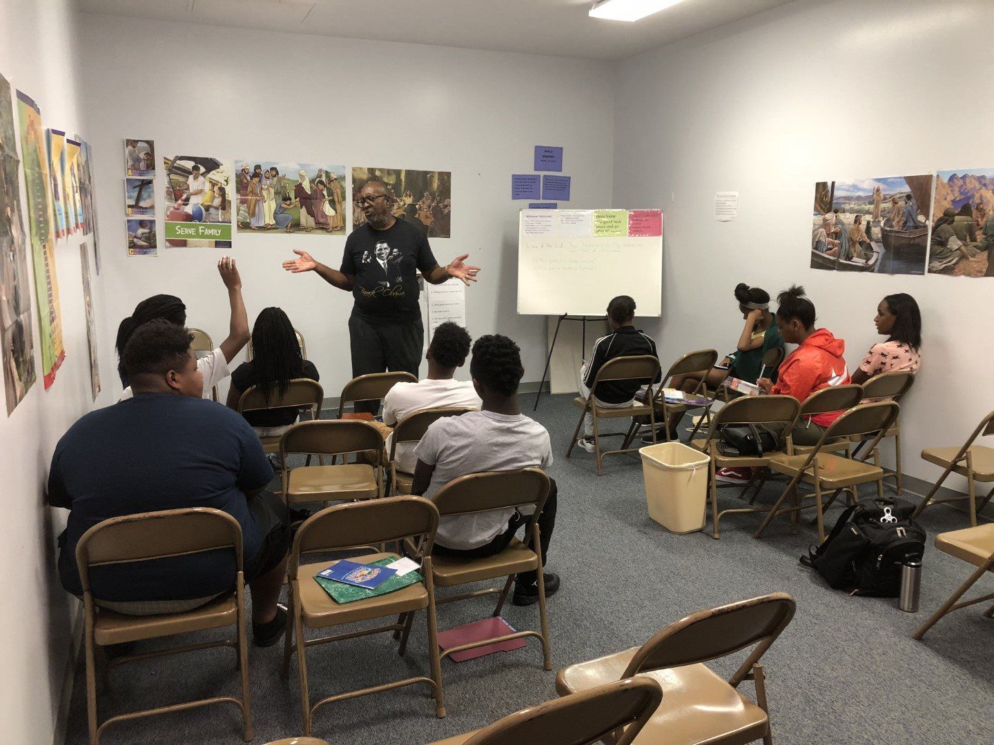 A man is giving a presentation to a group of people in a classroom.