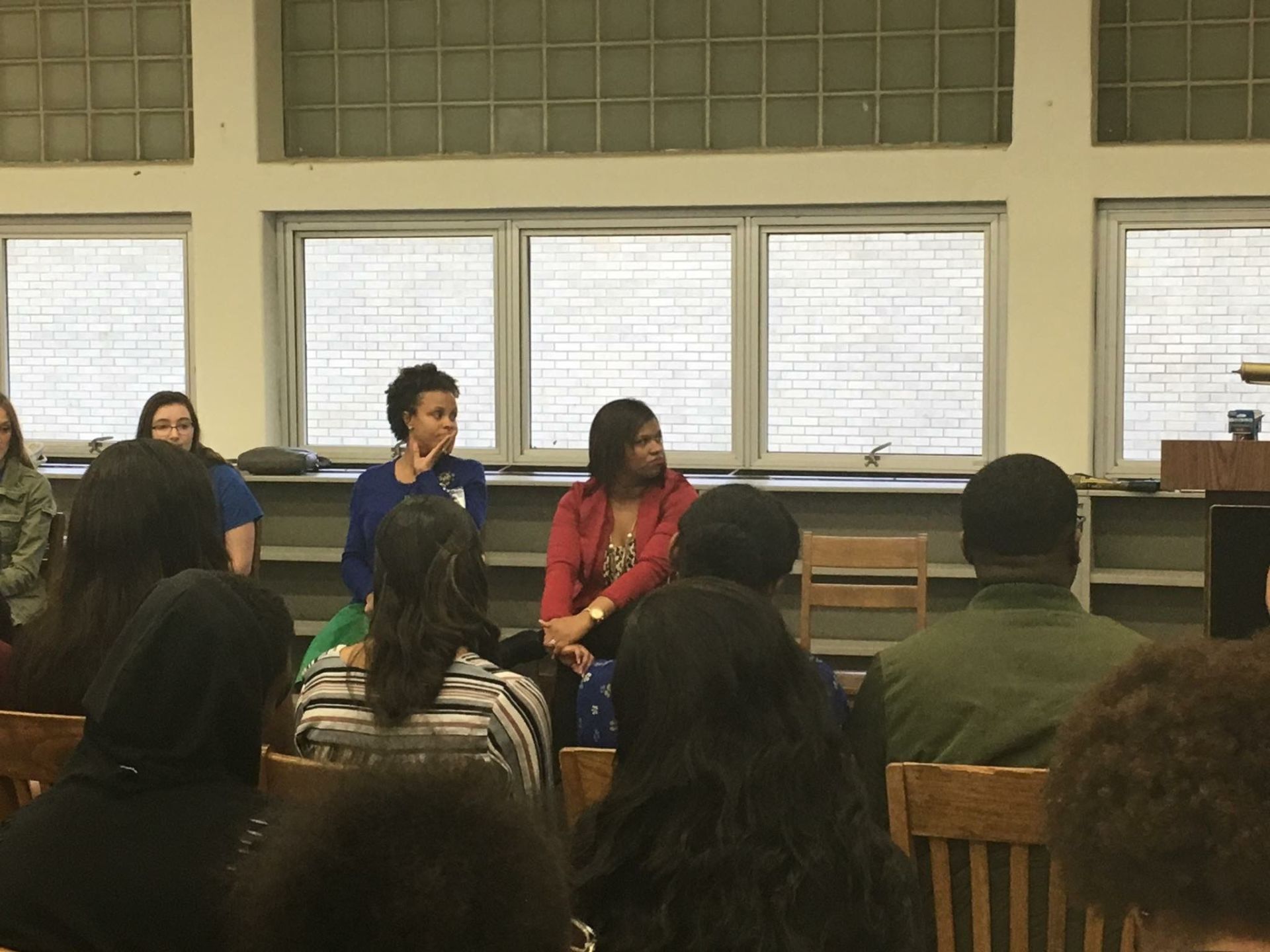 A group of people are sitting in chairs in a room.